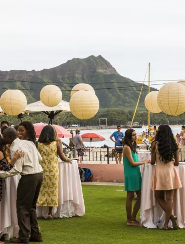 Guests celebrating at a wedding in Oahu with Waikiki Beach in the background